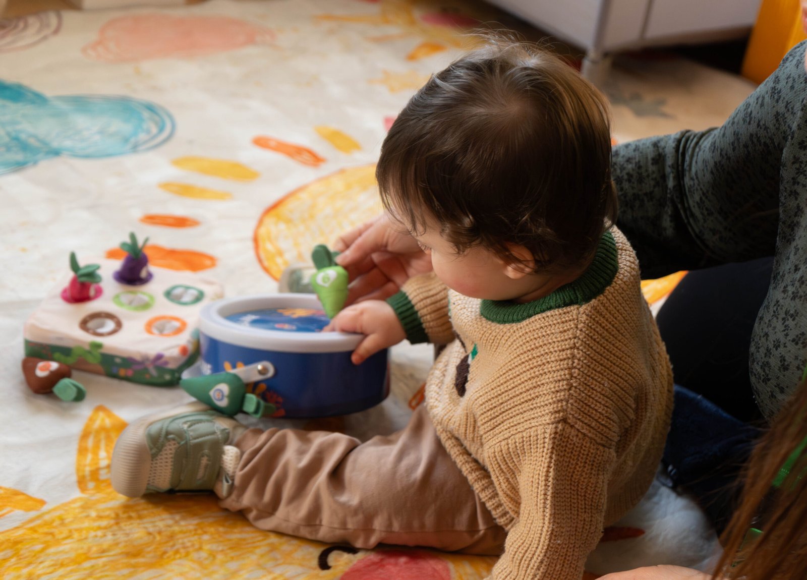 Young child engaged in hands-on play with a nursery practitioner at Little Lion Cubs Nursery in Netherfield, Nottingham, supporting early development through play-based learning.