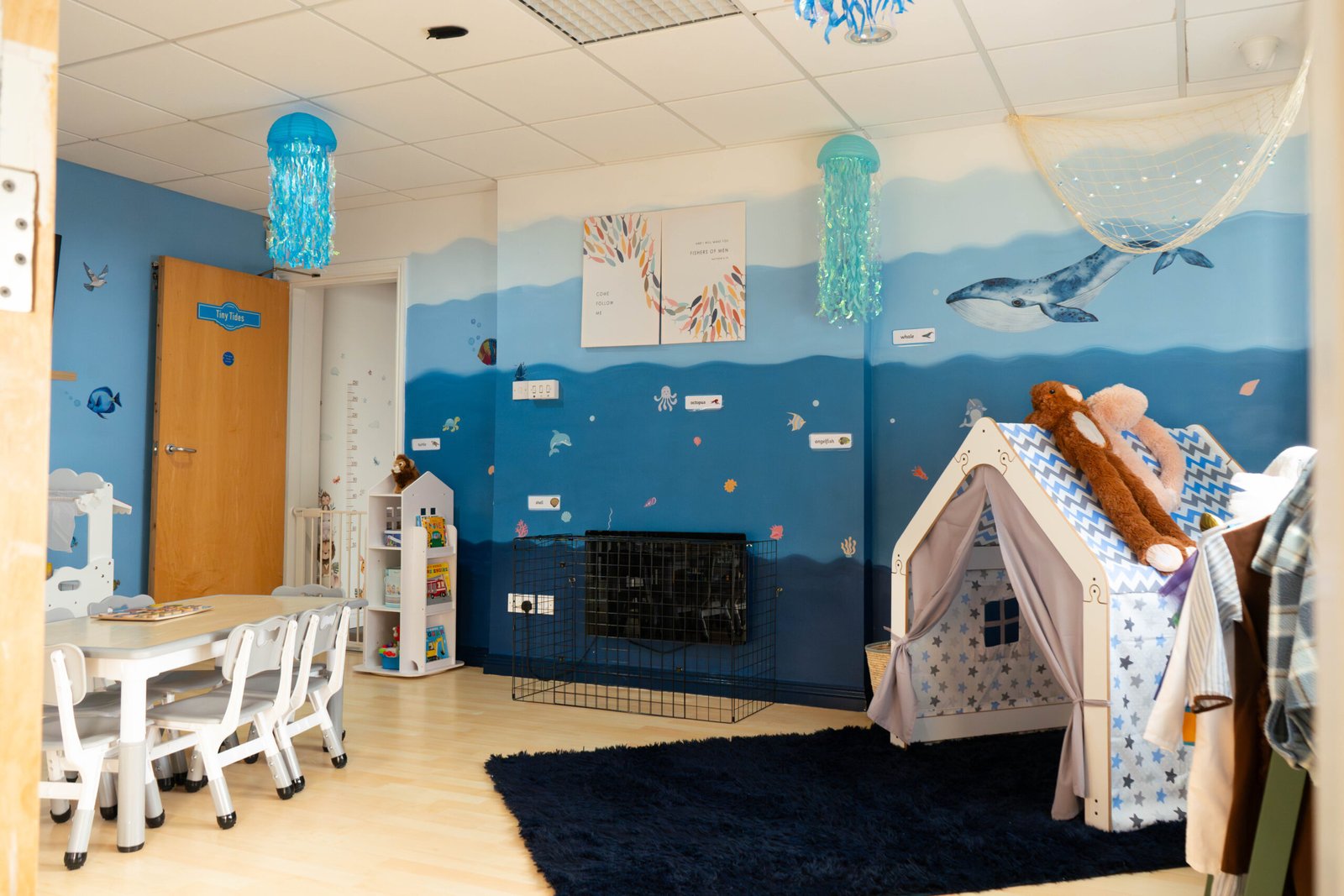 Under the Sea themed Tiny Tides room at Little Lion Cubs Nursery in Netherfield, Nottingham, featuring ocean wall murals, cosy reading den, child-sized tables, and a calm learning space for toddlers.